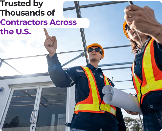Contractors in safety vests and helmets reviewing plans at a construction site, pointing to structure.